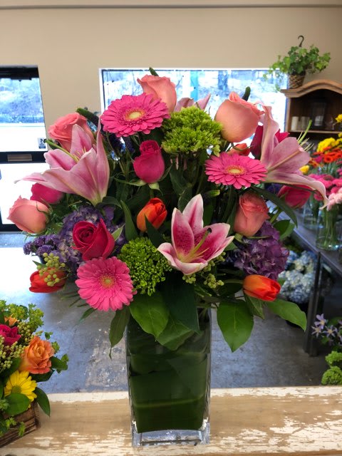 Pink and peach mixed bouquet in a tall glass vase