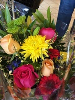 Mixed bouquet with roses and bright yellow flowers