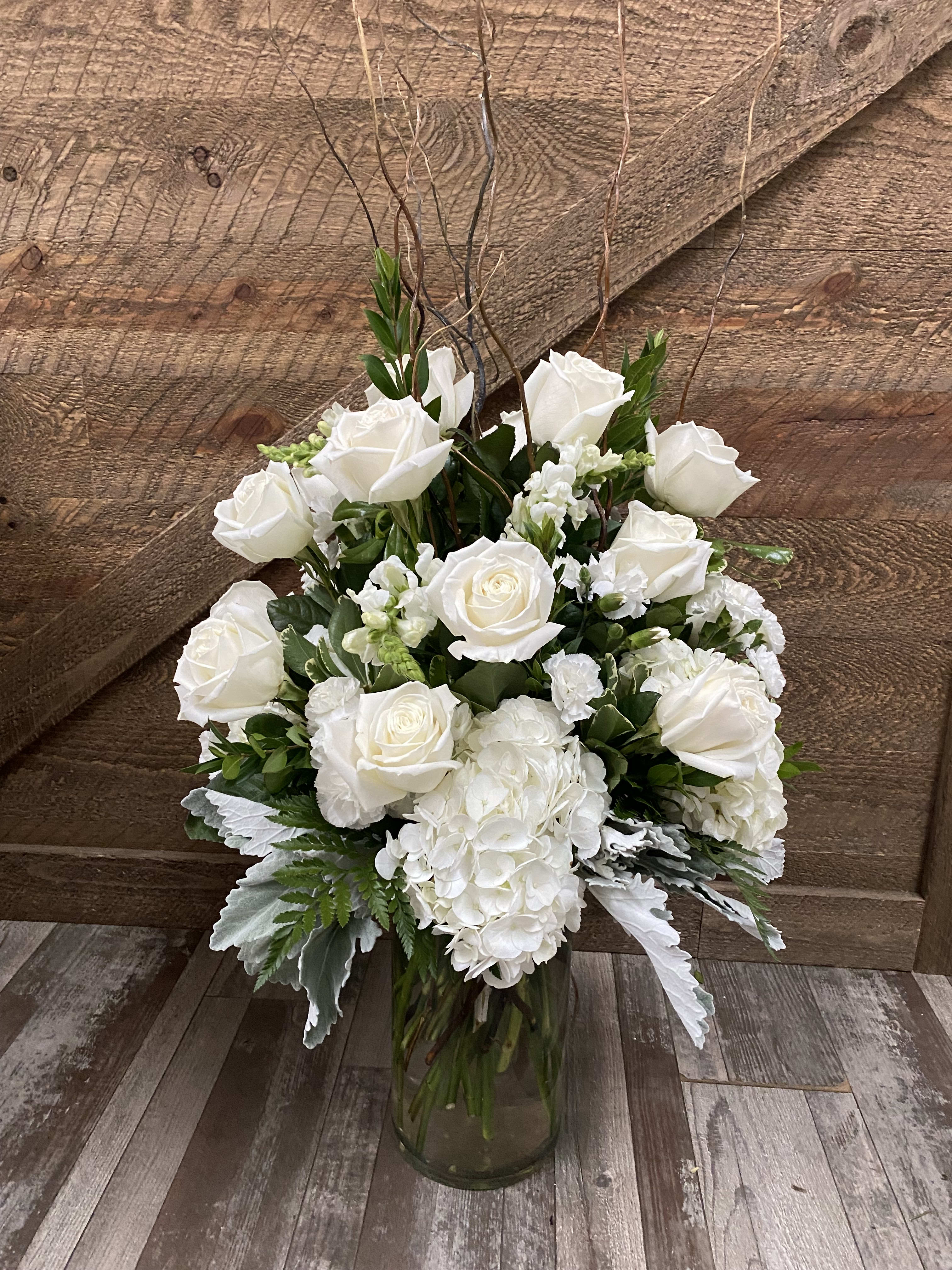 White roses and hydrangeas in a glass vase