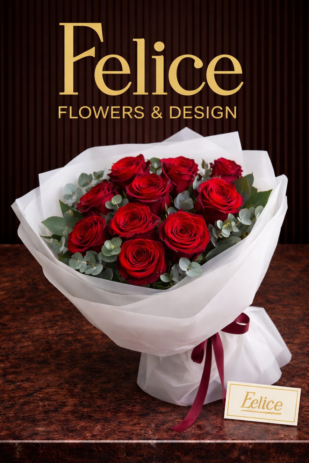 Bouquet of red roses wrapped in white paper with a burgundy ribbon