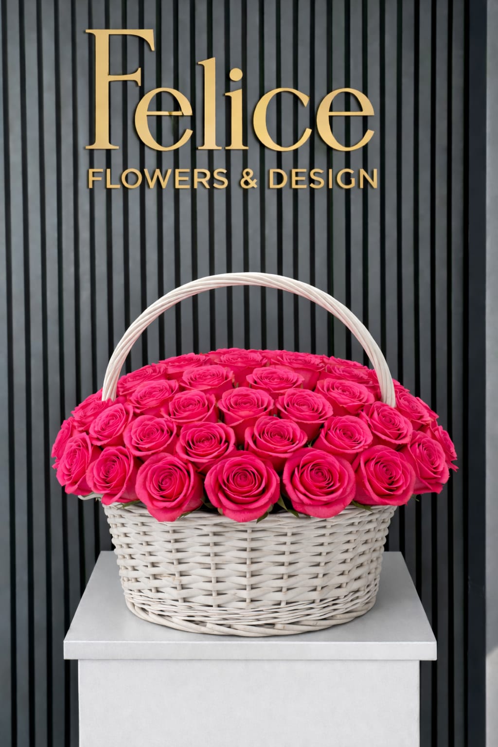 Basket of bright pink roses with a white handle