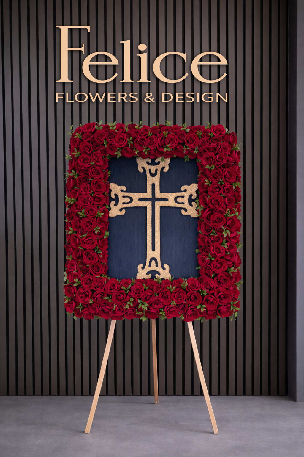 Standing floral cross covered in red roses on an easel