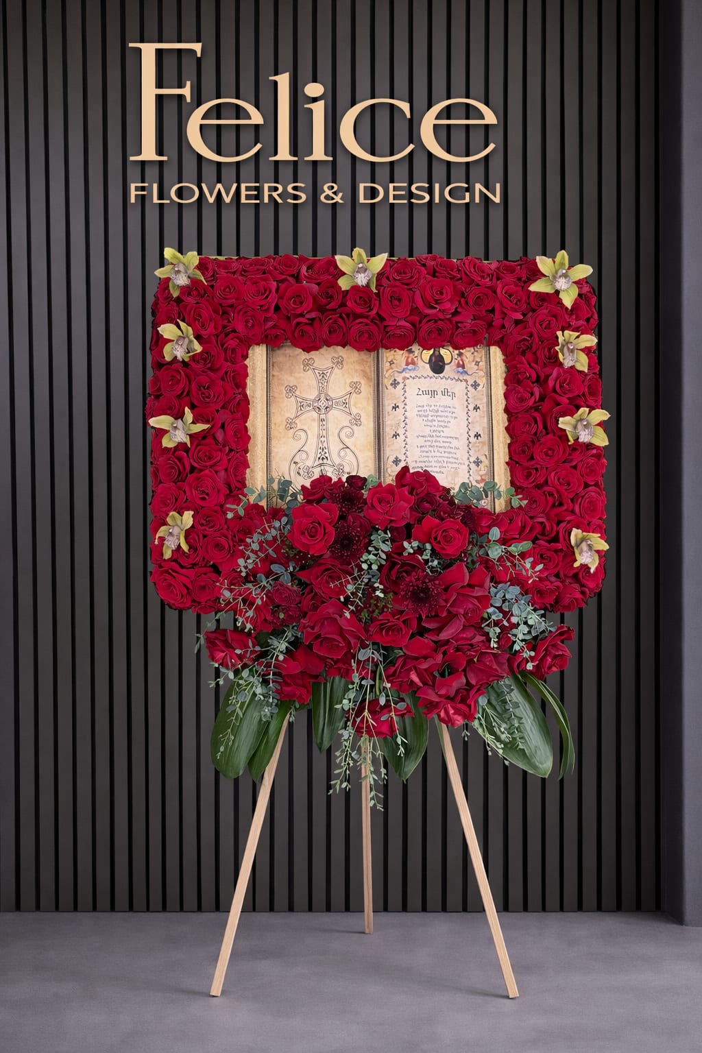 Standing floral easel with red roses and orchids around a framed tribute