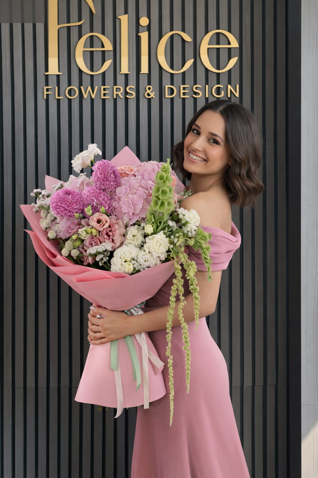 Woman holding a large pink bouquet in front of a flower shop sign