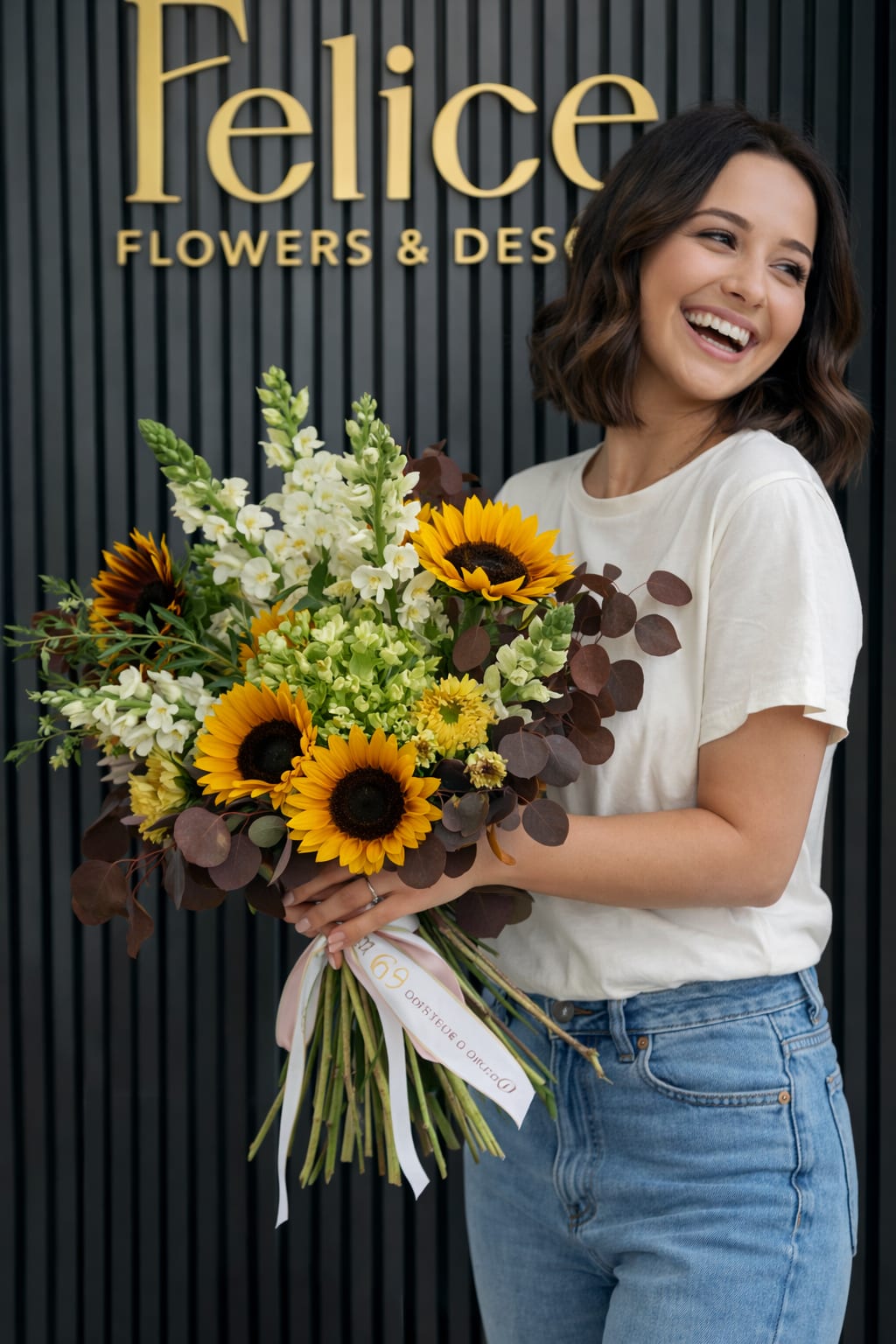 Woman holding a bouquet of sunflowers and white flowers