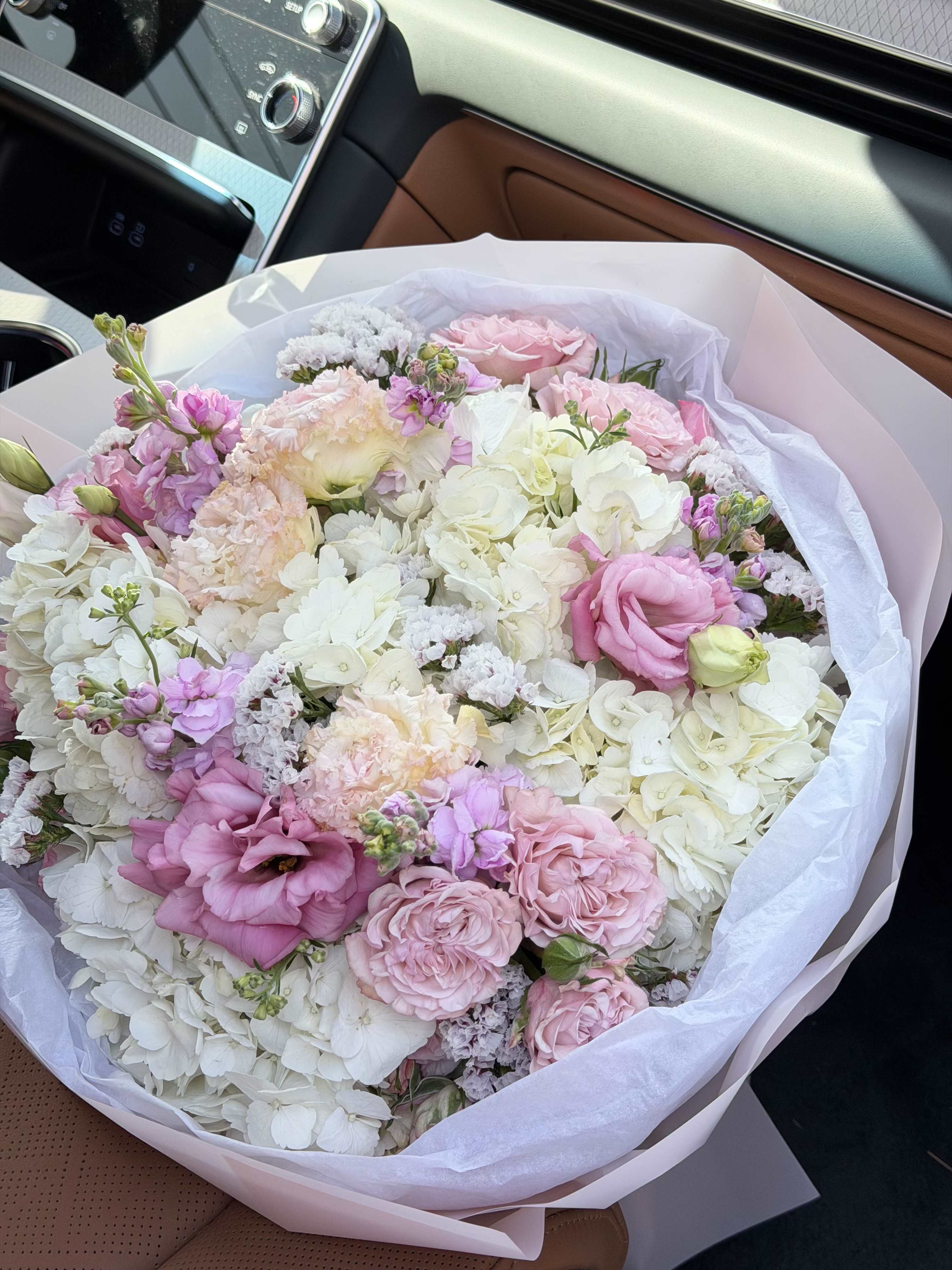 Blush Cloud Luxury Bouquet - An ultra-soft and luxurious bouquet designed in delicate blush pink and creamy white tones, featuring premium hydrangeas, roses, spray roses, lisianthus, and seasonal garden blooms. This arrangement has a cloud-like fullness with airy textures and a refined, romantic aesthetic. The soft pastel palette creates an elegant and calming feel, making it perfect for sophisticated gifting. Designed in a modern, elegant wrap, this bouquet offers a clean, high-end look with a natural garden-inspired style. Perfect for Birthday, Anniversary, Baby Shower, Bridal Gift, Thank You, Get Well, and Just Because. Please note: due to seasonal availability, some flowers may be substituted. However, the overall color palette, bouquet size, and soft luxurious style will remain consistent with the photo. Handcrafted by Felice Flowers &amp; Design.