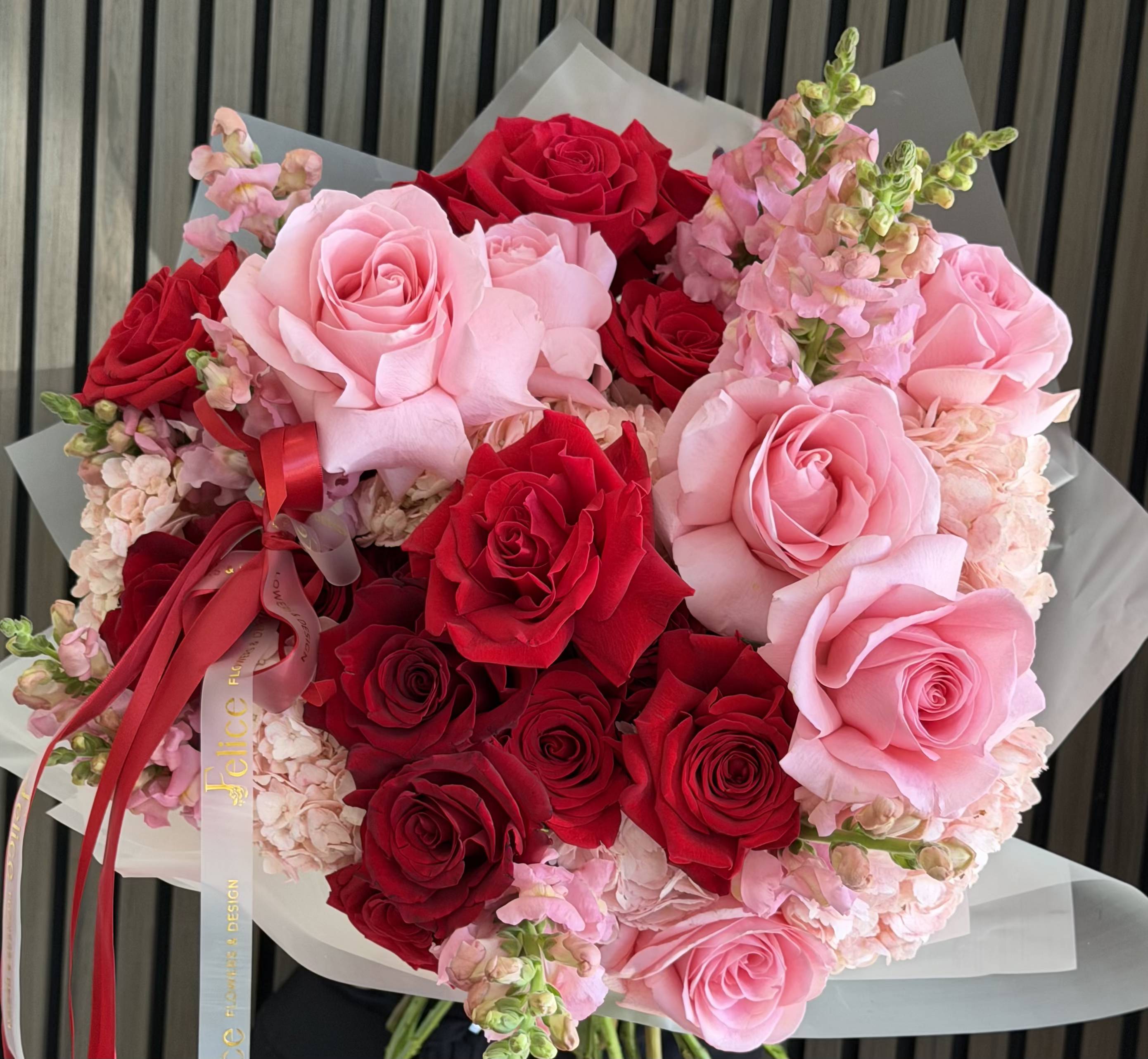 Romantic Red &amp; Blush Bouquet - A romantic and elegant bouquet featuring a stunning combination of red and blush pink roses, beautifully accented with soft seasonal blooms. The rich red roses symbolize deep love and passion, while the soft pink tones add a touch of tenderness and charm. Designed in a lush, full composition, this bouquet creates a perfect balance between bold and delicate. Wrapped in premium white paper with signature Felice Flowers &amp; Design ribbon, this arrangement is crafted to impress and express emotion effortlessly. Perfect for Anniversary, Birthday, Valentine’s Day, or any romantic occasion. Please note: flower varieties may vary slightly due to seasonality, while maintaining the same color palette and overall look.