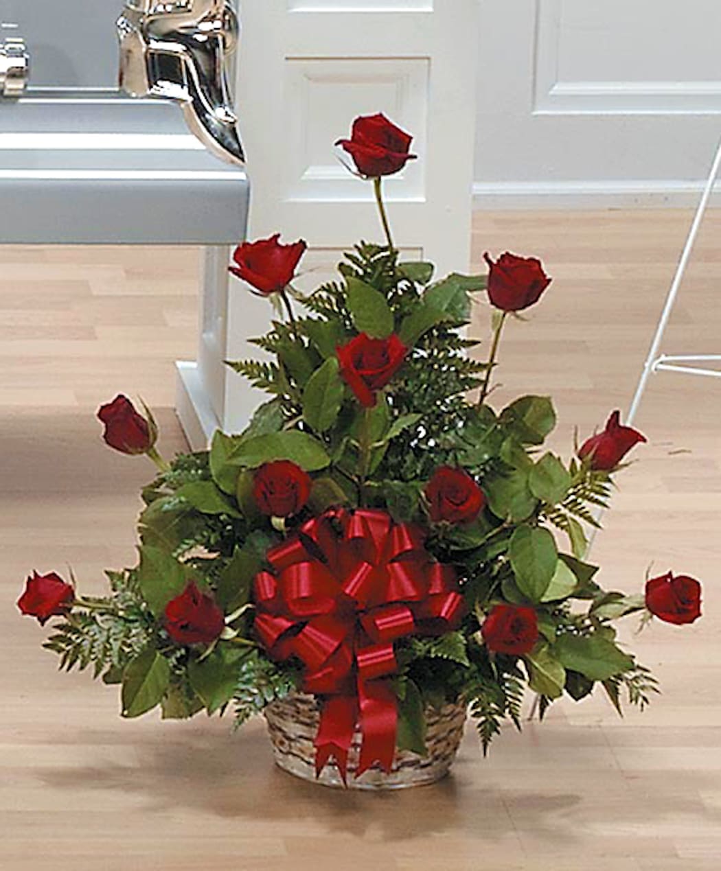 Basket arrangement of red roses with a large red ribbon bow