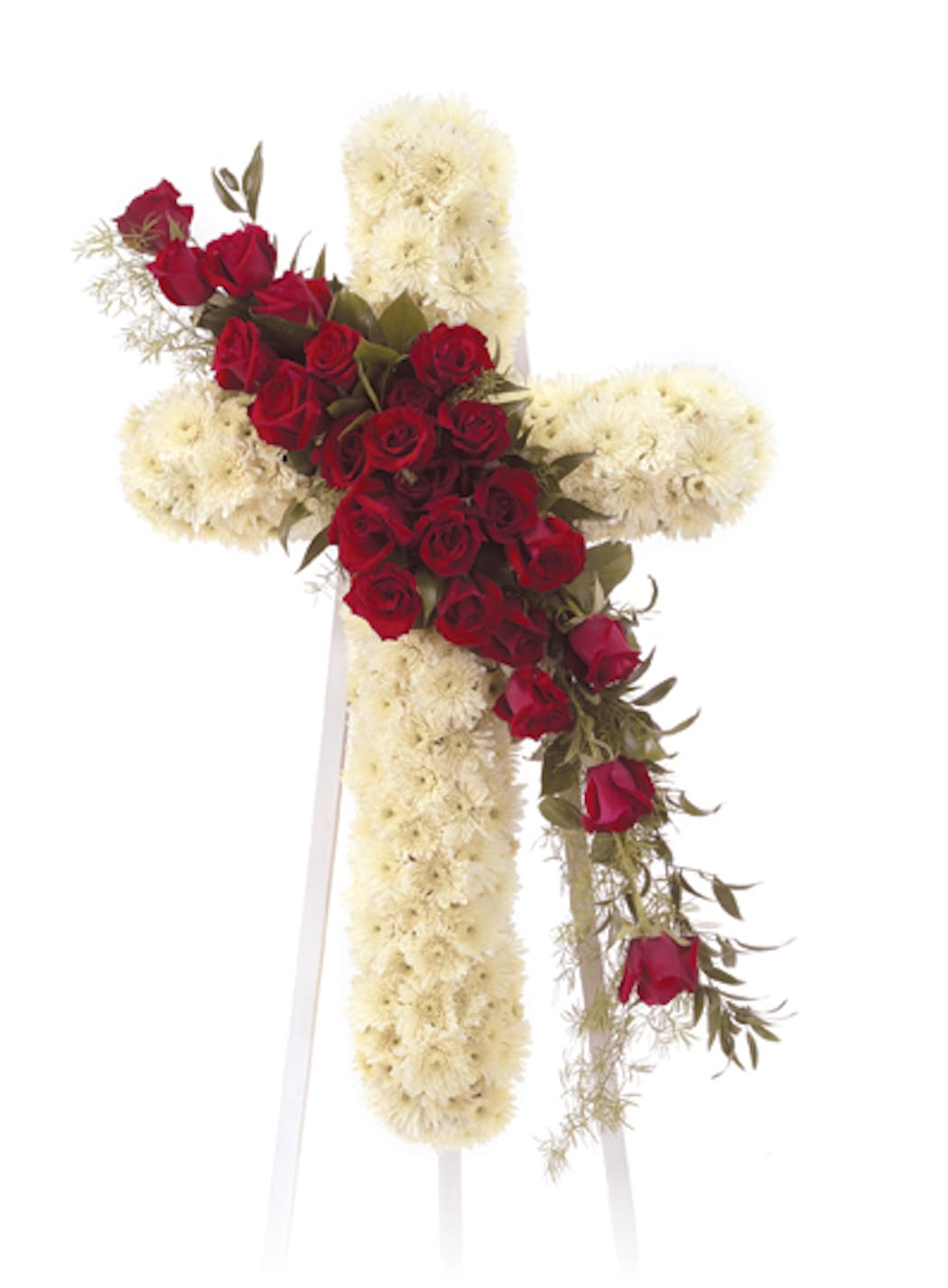 Standing cross of white flowers accented with cascading red roses on an easel.