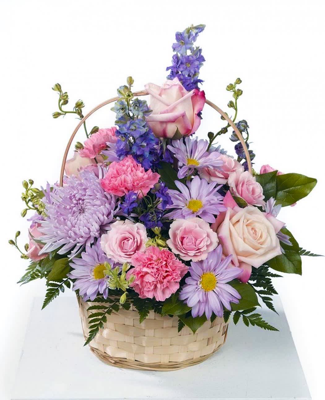 Pastel pink and lavender mixed flower basket with roses, carnations, daisies, and delphinium