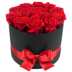 Round black hatbox of red roses with a red ribbon and bow