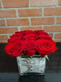 Rustic Rose by Manny  - This eye-catching arrangement offers a modern twist on the classic dozen. Rustic Rose by BloomNation™ makes a great gift for Valentine's Day, a birthday, or just to let someone know you're thinking of them.  Arrangement Details: 12 Red Roses in a Wooden Box APPROXIMATE DIMENSIONS: 11" H X 8" L X 8"W