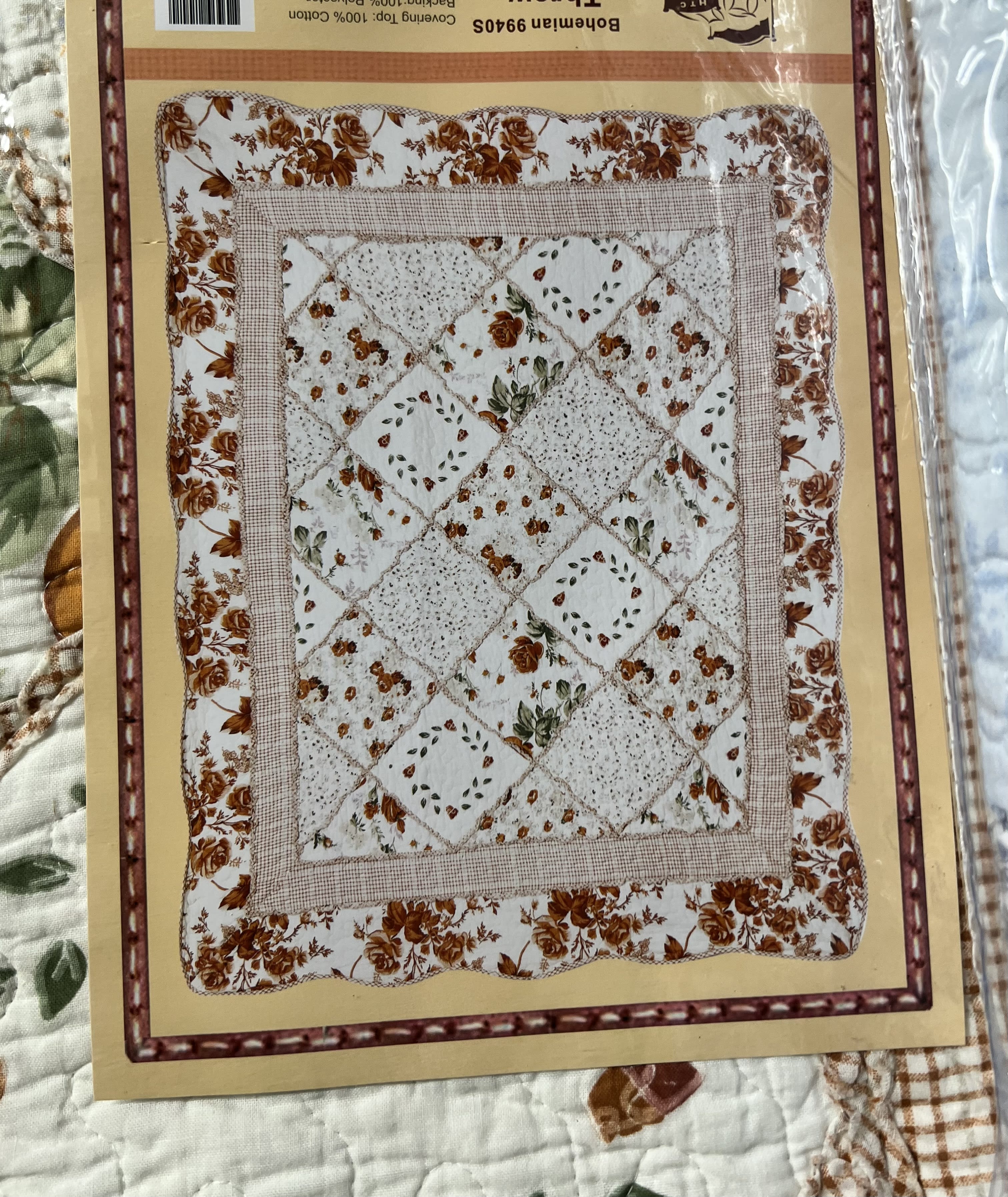 Packaged quilt with a floral patchwork pattern in cream and brown
