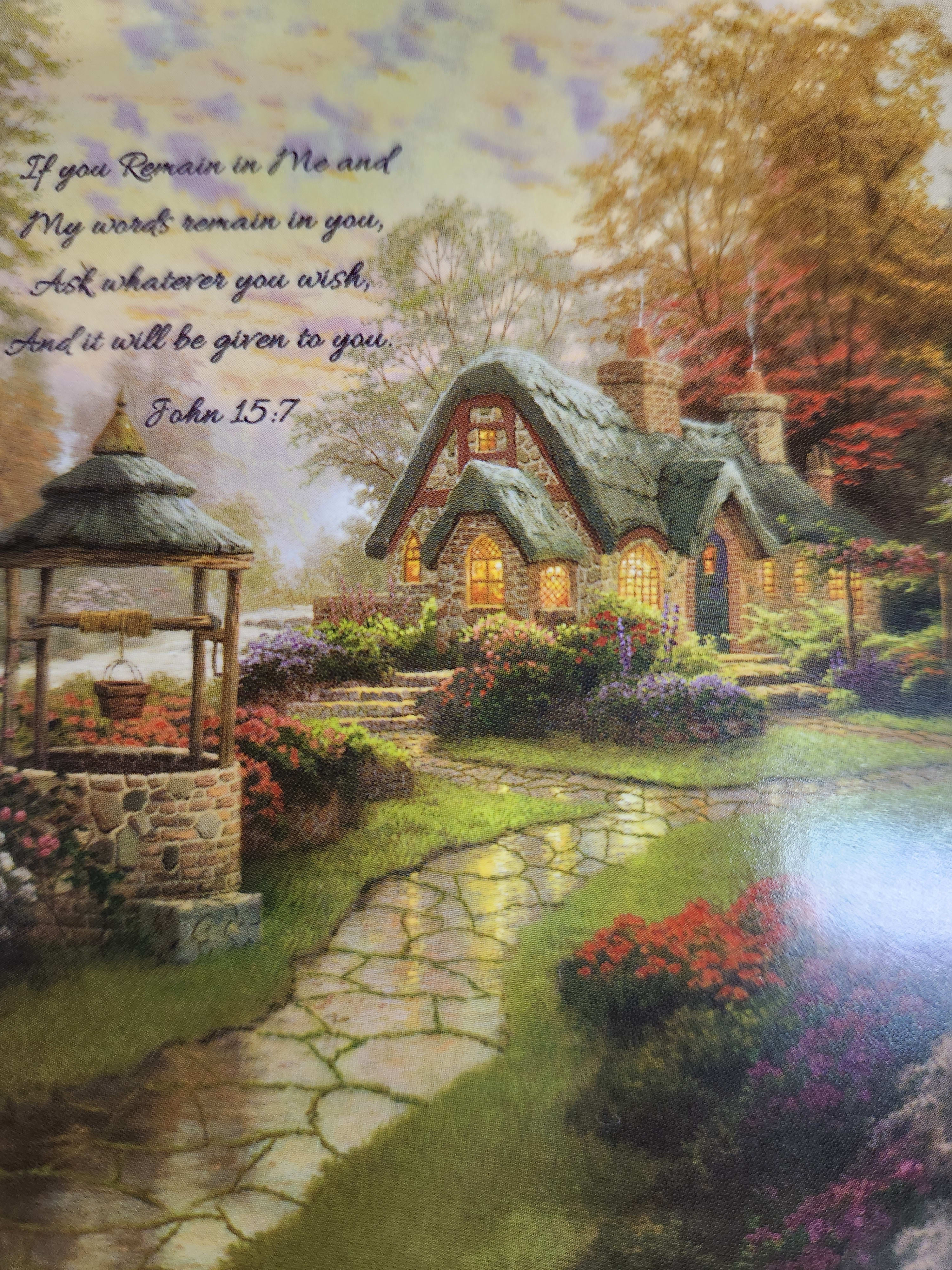 Decorative cottage scene with a Bible verse and flower beds