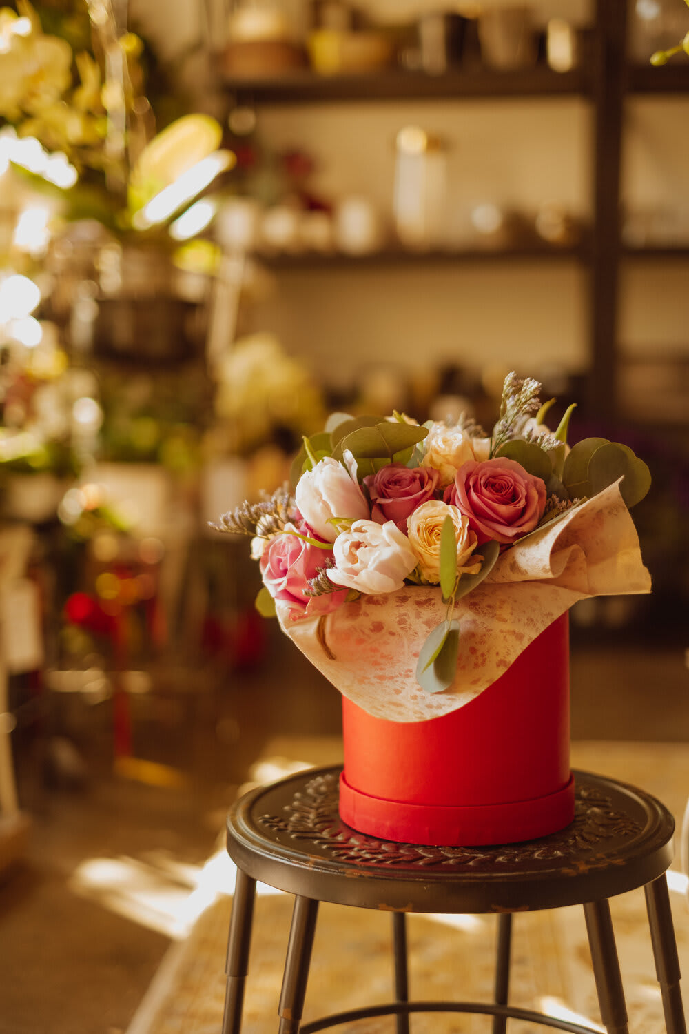Bouquet of pink and white roses in a red hat box