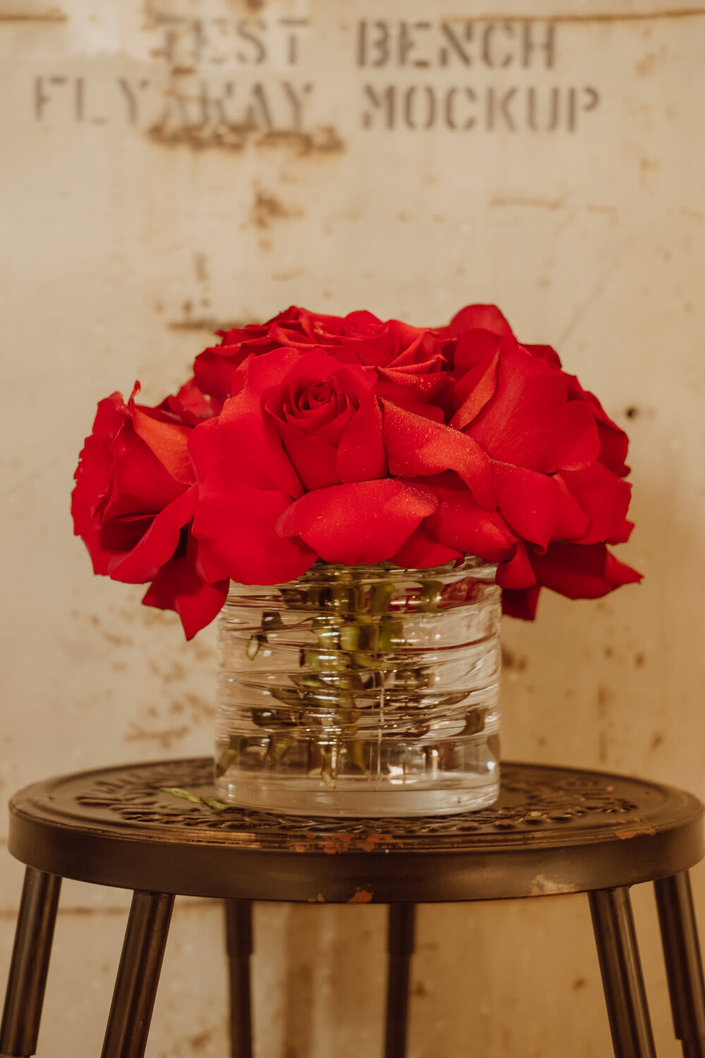 Red roses arranged in a clear glass vase