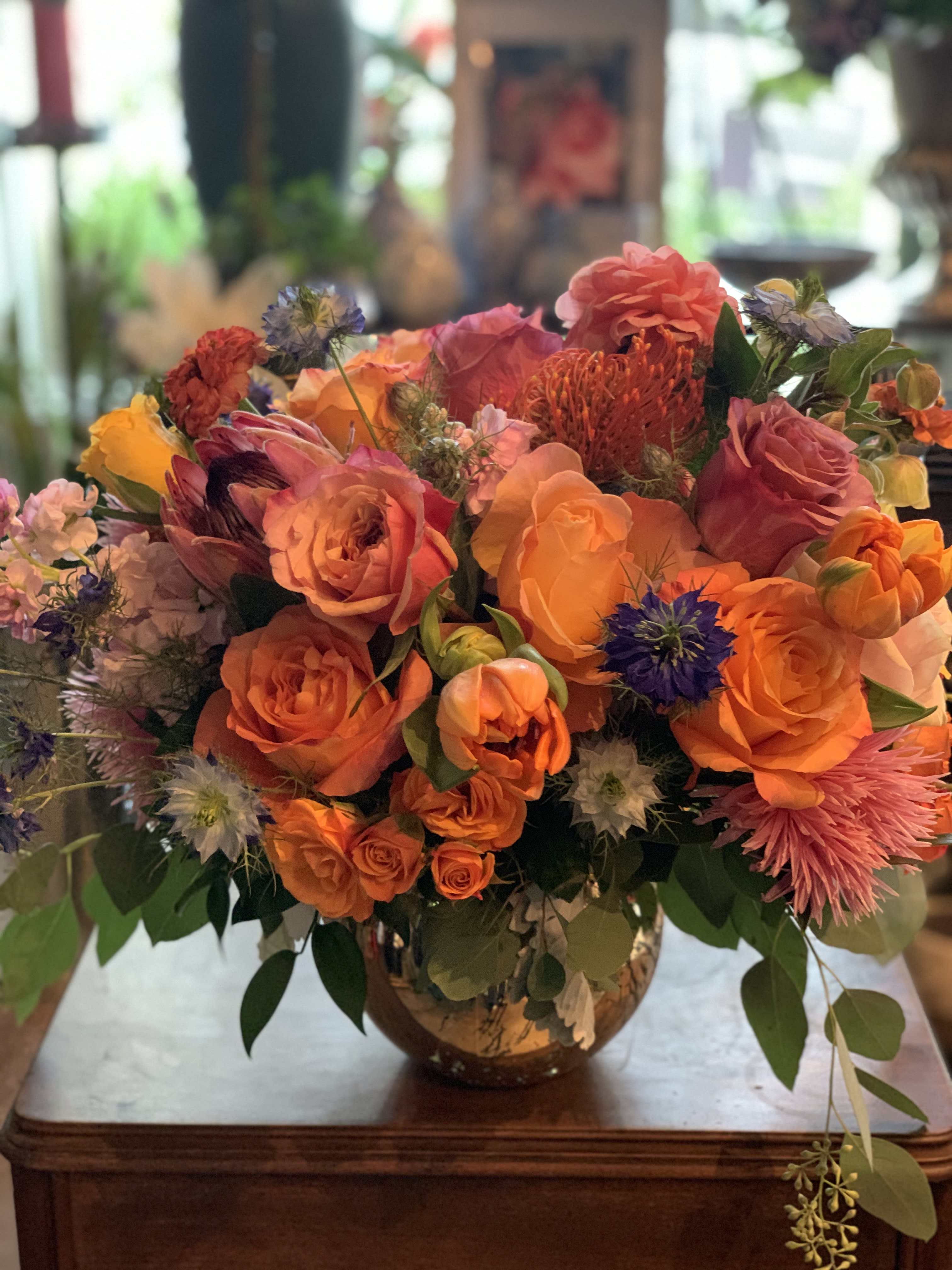 Bright orange and pink bouquet in a glass vase