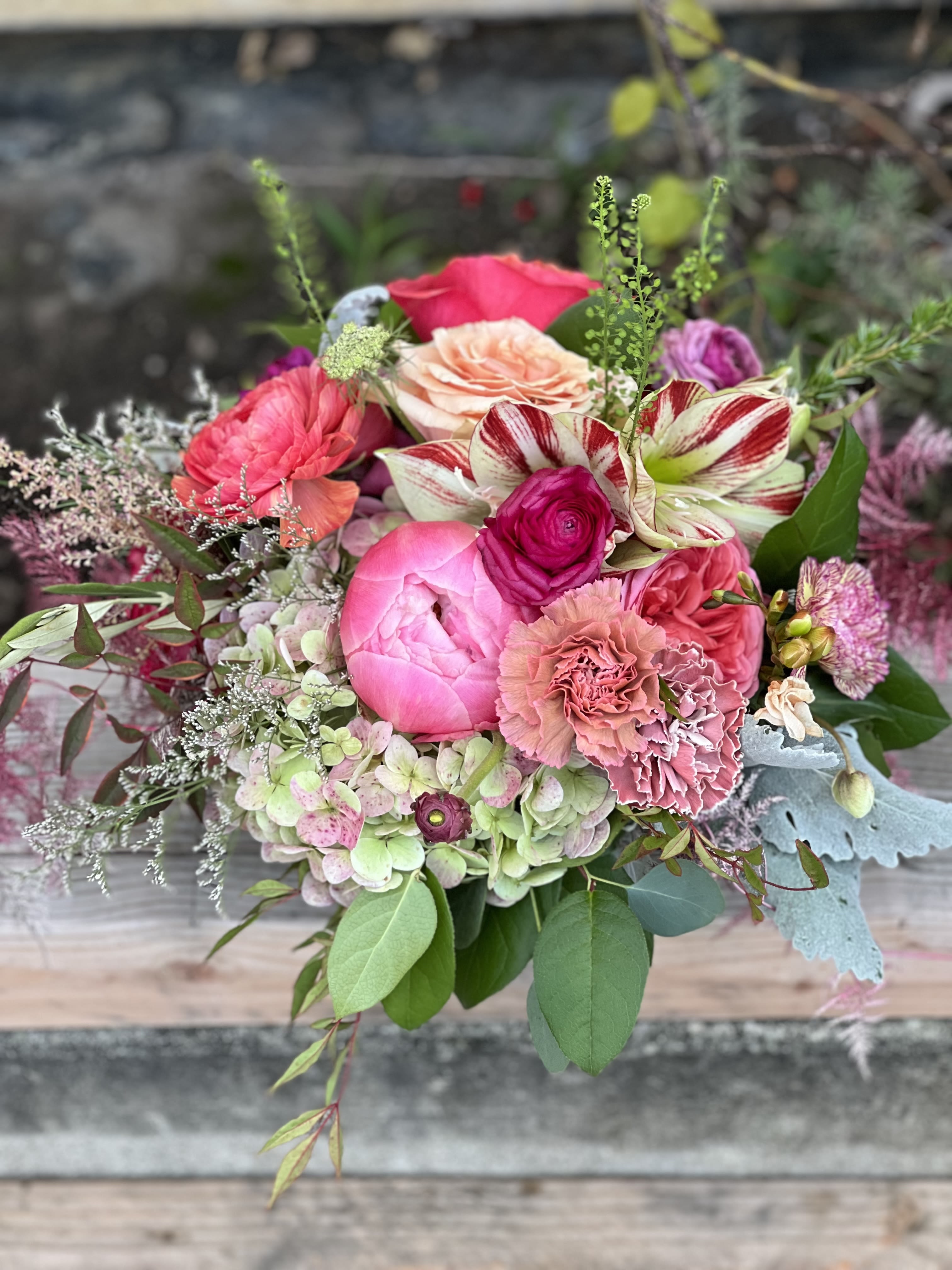 Mixed bouquet of pink and peach flowers with striped blooms