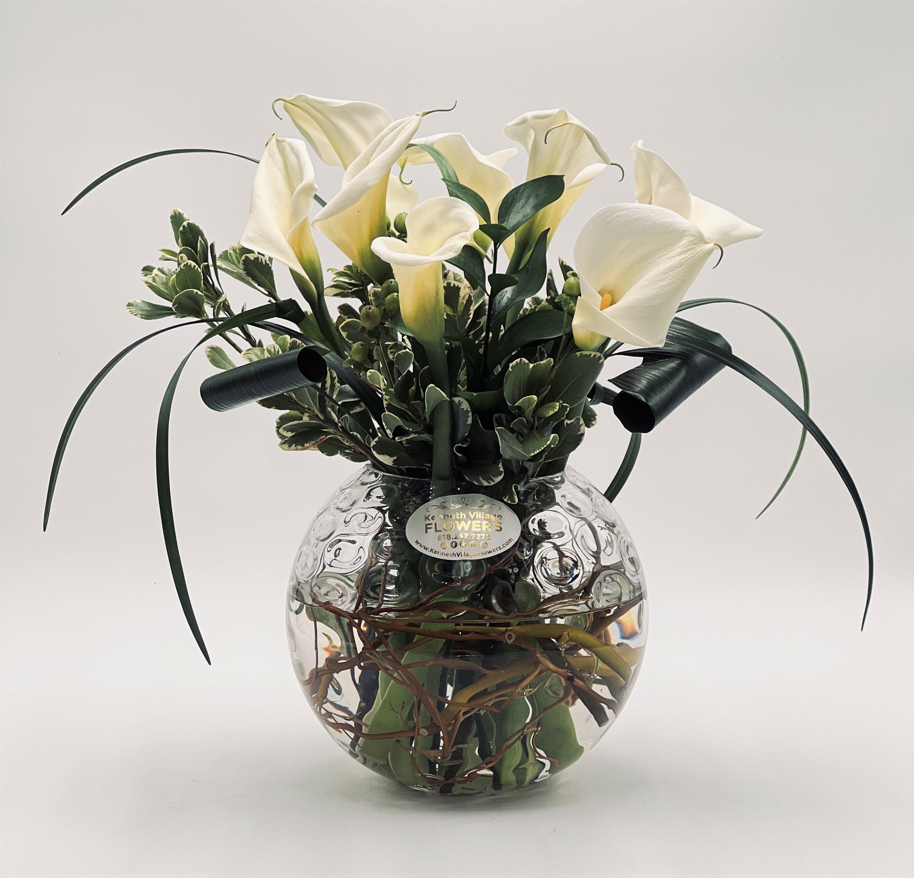 Calla Lily Bowl - For a truly original gift, choose this glass bubble bowl lined with vines and topped with an eye-catching arrangement of pure white calla lilies, hypericum berries and greenery. It’s a unique design that’s sure to capture their attention.
