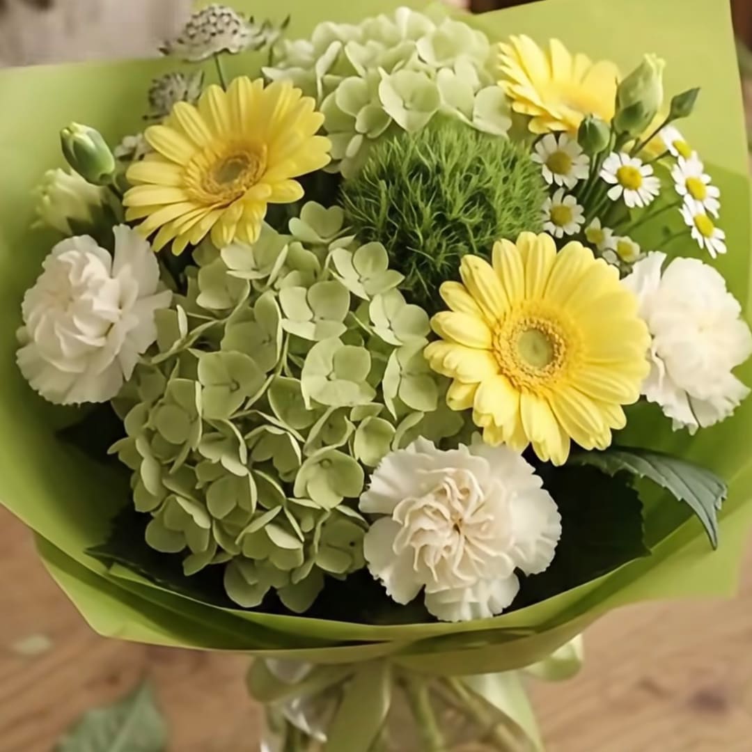 Bouquet of yellow gerbera daisies and white carnations with green hydrangea