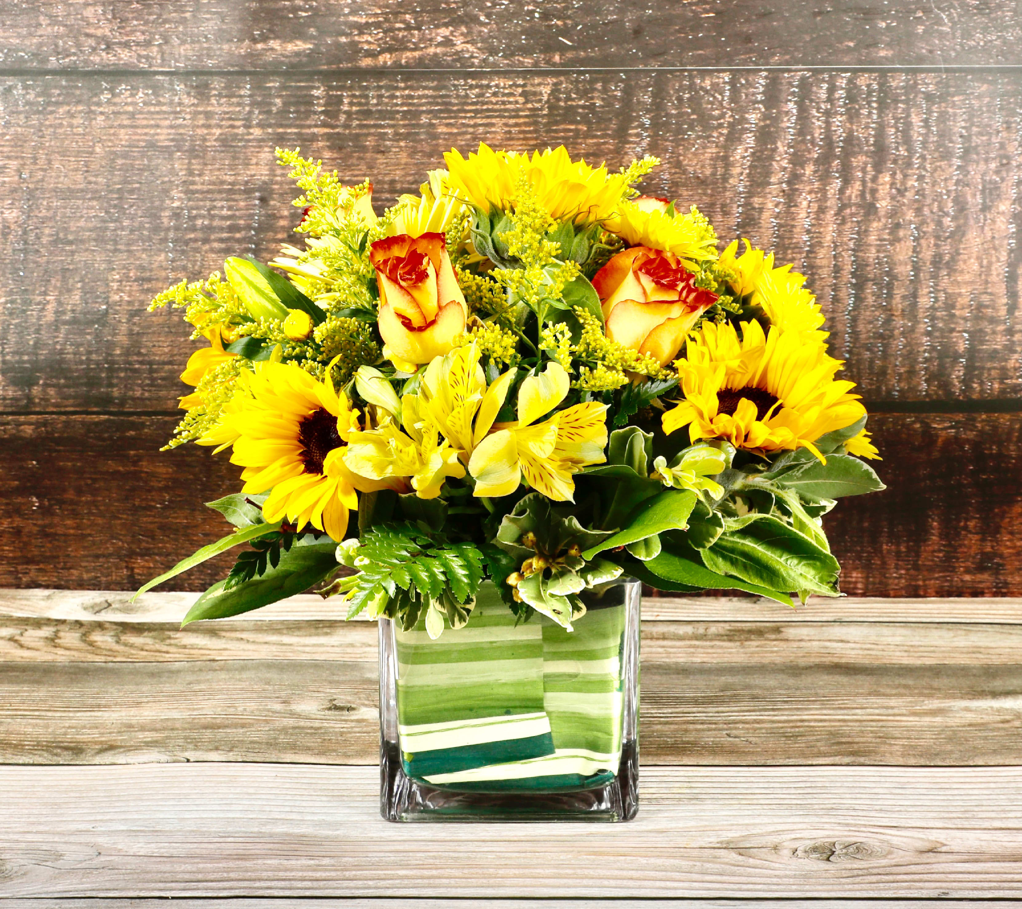 Sunflower Special - This beautiful square container includes sunflowers, roses and alstroemerias. 