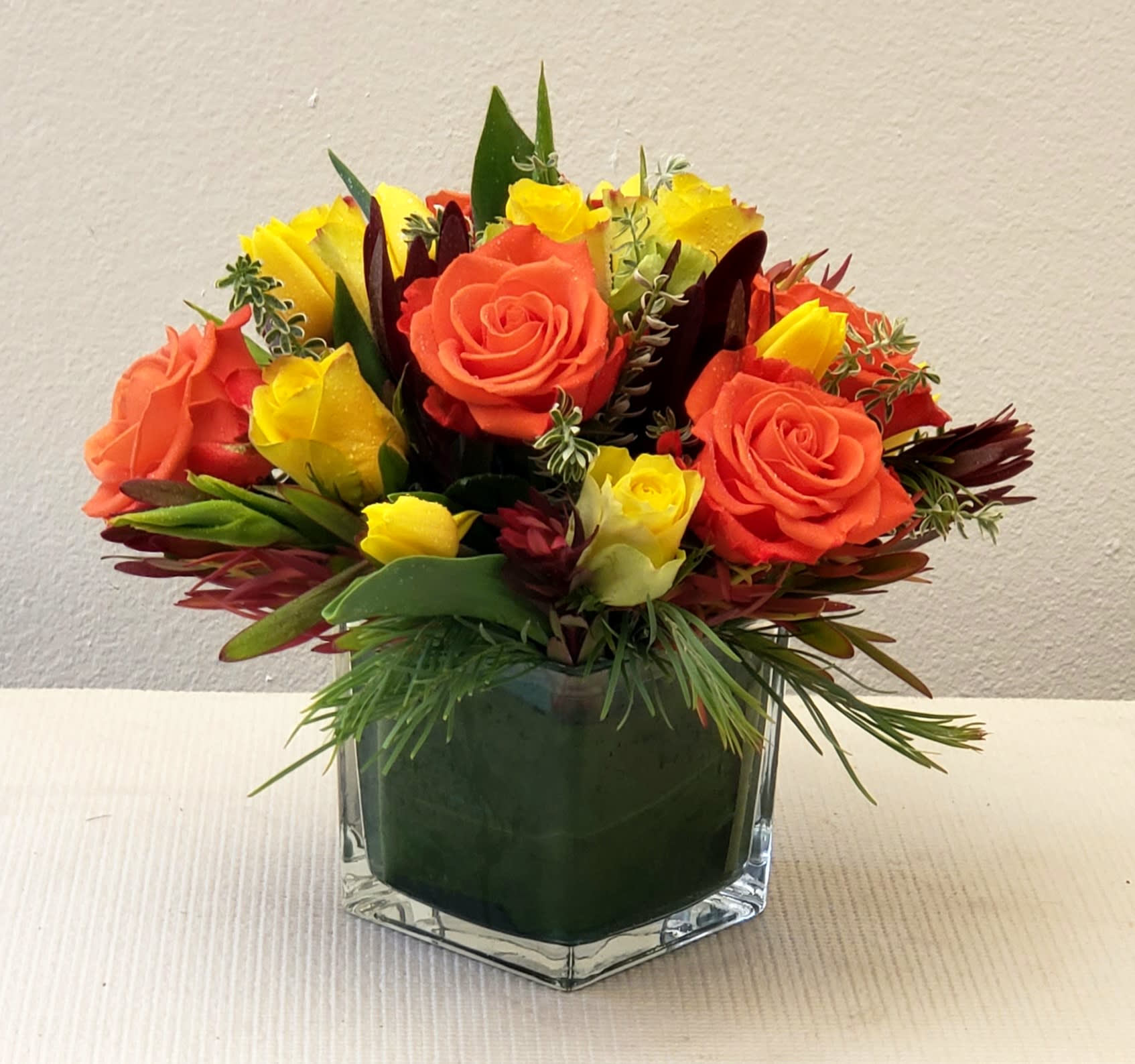 Cheers to Autumn Bouquet - Cheers to the Autumn flower arrangement in orange and soft yellow. The delivery of this bouquet comes in a clear glass vase, as shown. Approximately 12" H x 12" W. 