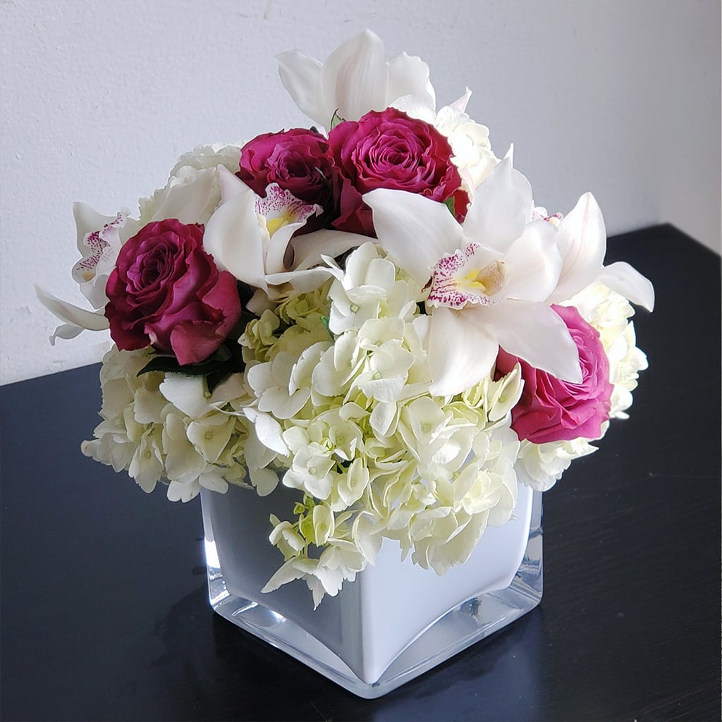 Sweet Moment Bouquet - Celebrate life's sweetest moments with our beautiful Sweet Moment Bouquet! Expertly crafted by our local florist stylists, this stunning arrangement features shades of pink and white. From birthdays to anniversaries and everything in between, the Sweet Moment Bouquet is the perfect way to show someone special just how much you care. Order online for same-day delivery, and let us help you make every moment a little sweeter! Approximately: 10" H x 9" W. Glass square vase 5X5.  