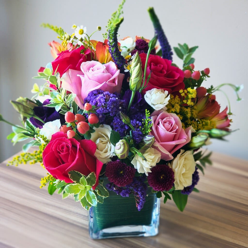 Celebration Bouquet - Brighten their day with our handcrafted Celebration Bouquet, bursting with fresh roses and seasonal blooms in a joyful mix of colors.   Perfect for birthdays, anniversaries, special moments or just because.  Approximately 14"H x 14" W.  Same-day delivery available, surprise someone special today!