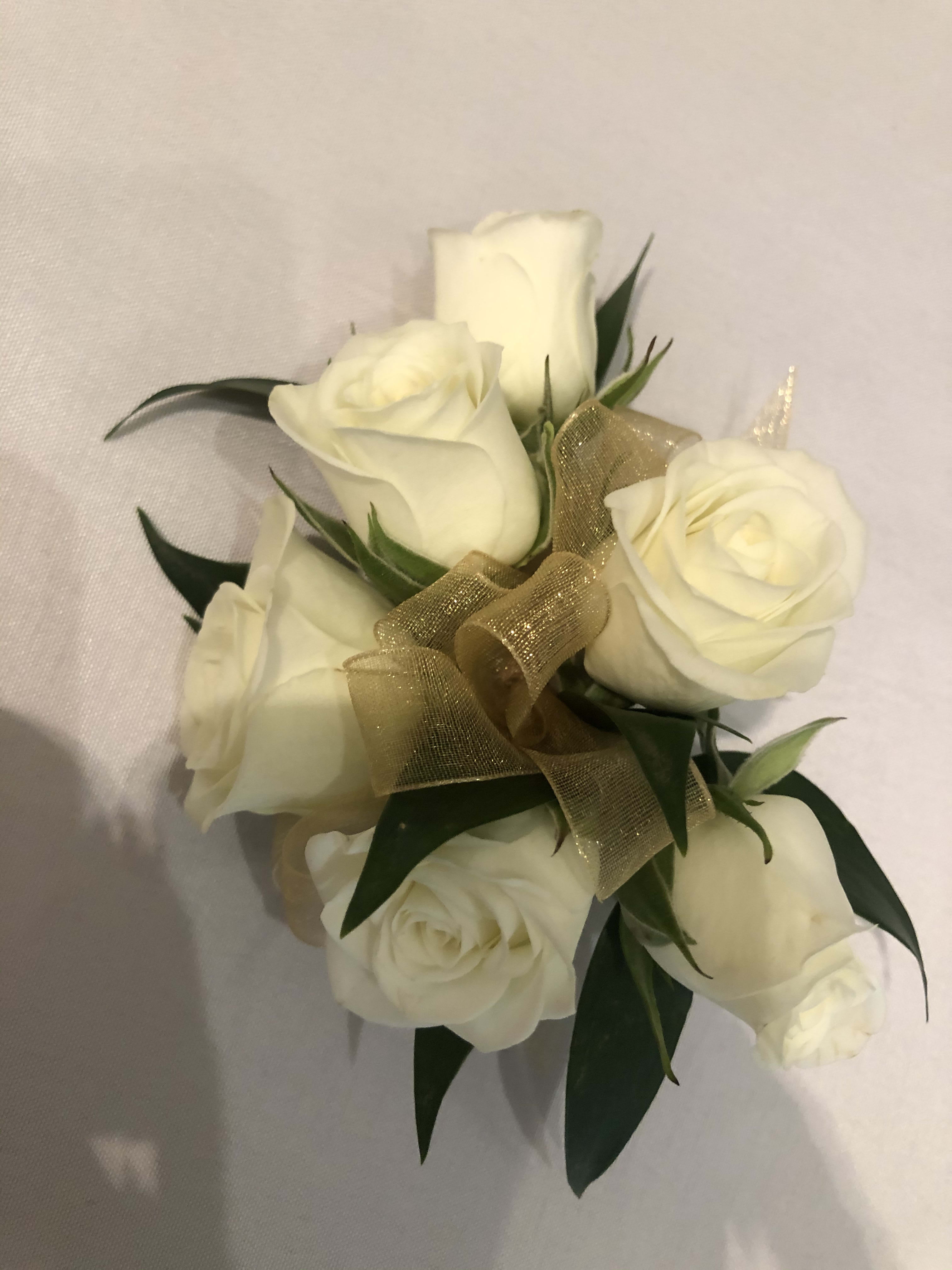 White rose corsage - White roses, ribbon and greens for pin on or for on a wristlet available in other colors as well. 