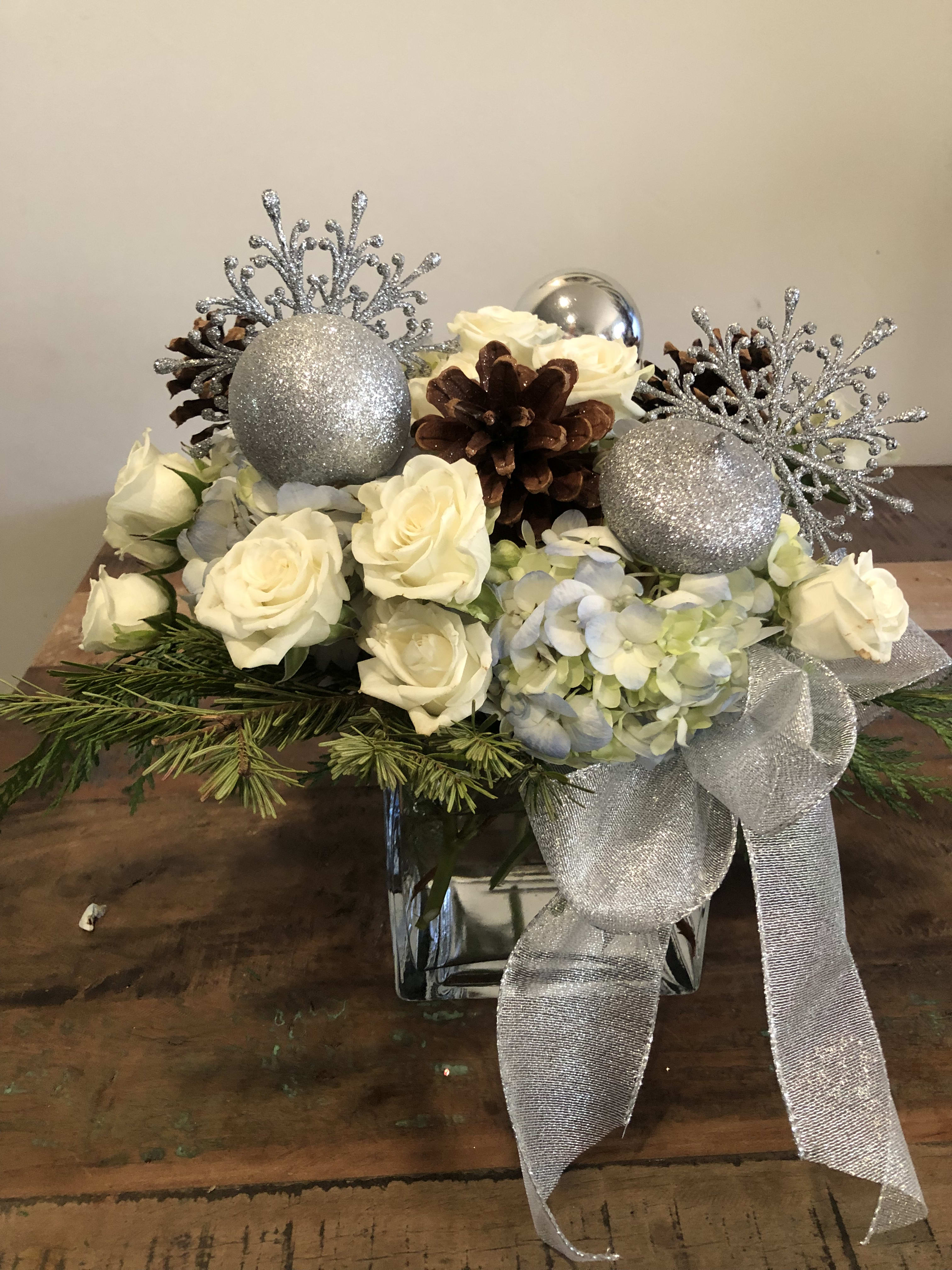 Snowflake celebration - Blue hydrangea, white roses, ornaments. Pine cones and ribbon 
