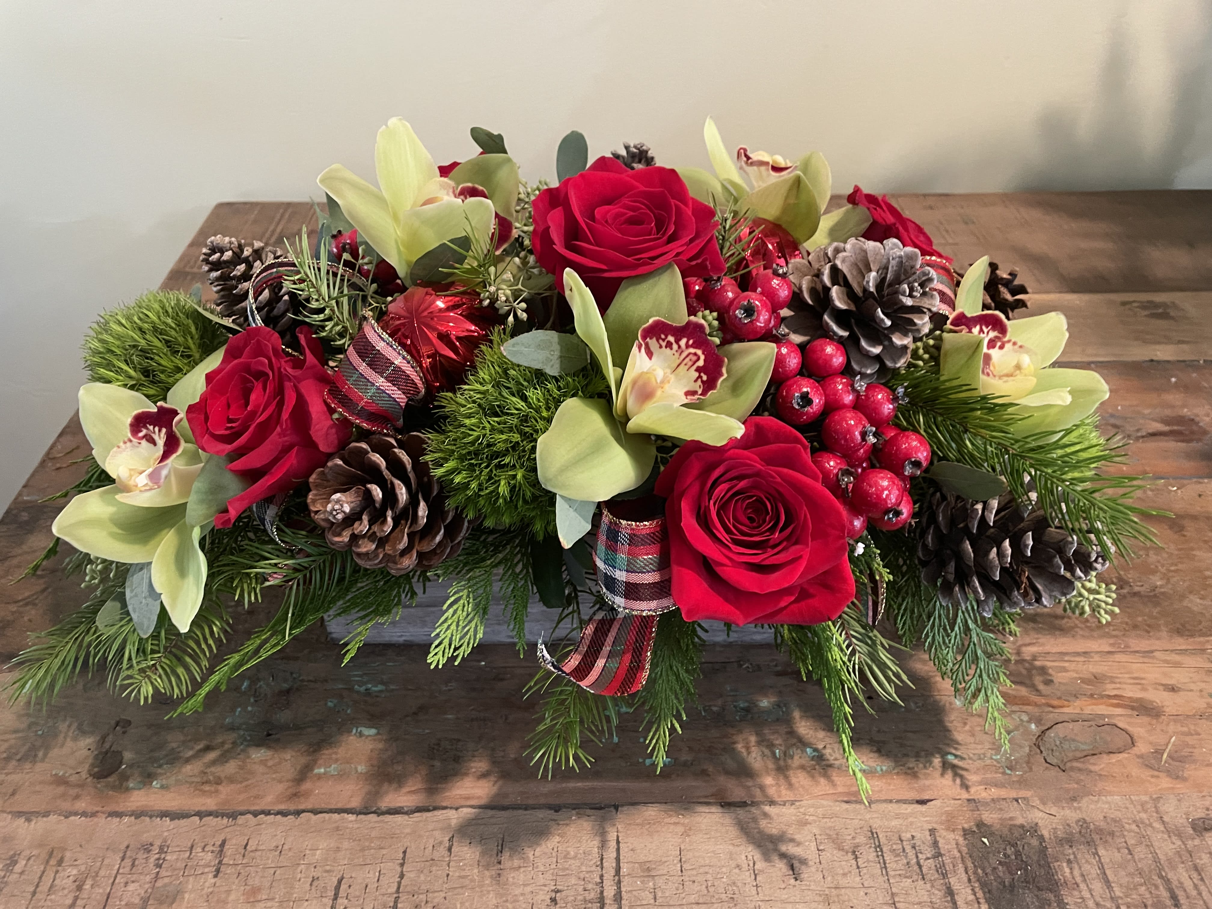 Feast of Carol's - Green cymbidiums, red roses, green ball dianthus and other adornments will brighten any holiday table