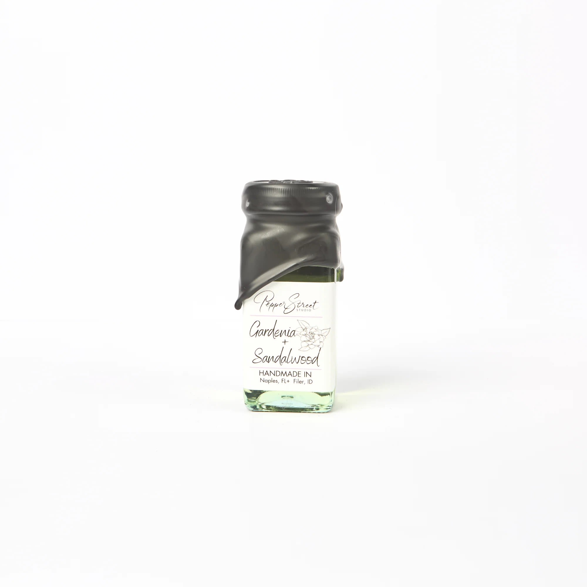 GARDENIA + SANDALWOOD MINI ROOM DIFFUSER - Pepper Street's signature black wax and hand-dipped room diffuser, in a square glass bottle. It includes ten bamboo reeds for a sweet touch and effective scent diffusion. Their diffuser oils are wholly toxin-free and contain no additional alcohol, ensuring a long-lasting scent that will last you longer than eight months. A pull tab on the back allows easy access to the lid.  Bottle size: 4 fluid ounces. Gardenia + Sandalwood Experience the ultimate indulgence with our gardenia and sandalwood scent. The exquisite blend of these two fragrances creates a luxurious and calming atmosphere, perfect for unwinding after a long and tiring day. The gardenia notes are sweet and floral, providing a gentle and calming effect on the senses. At the same time, the sandalwood adds a touch of warmth and earthiness to the mix, promoting a serene environment. Linen gift bag included.