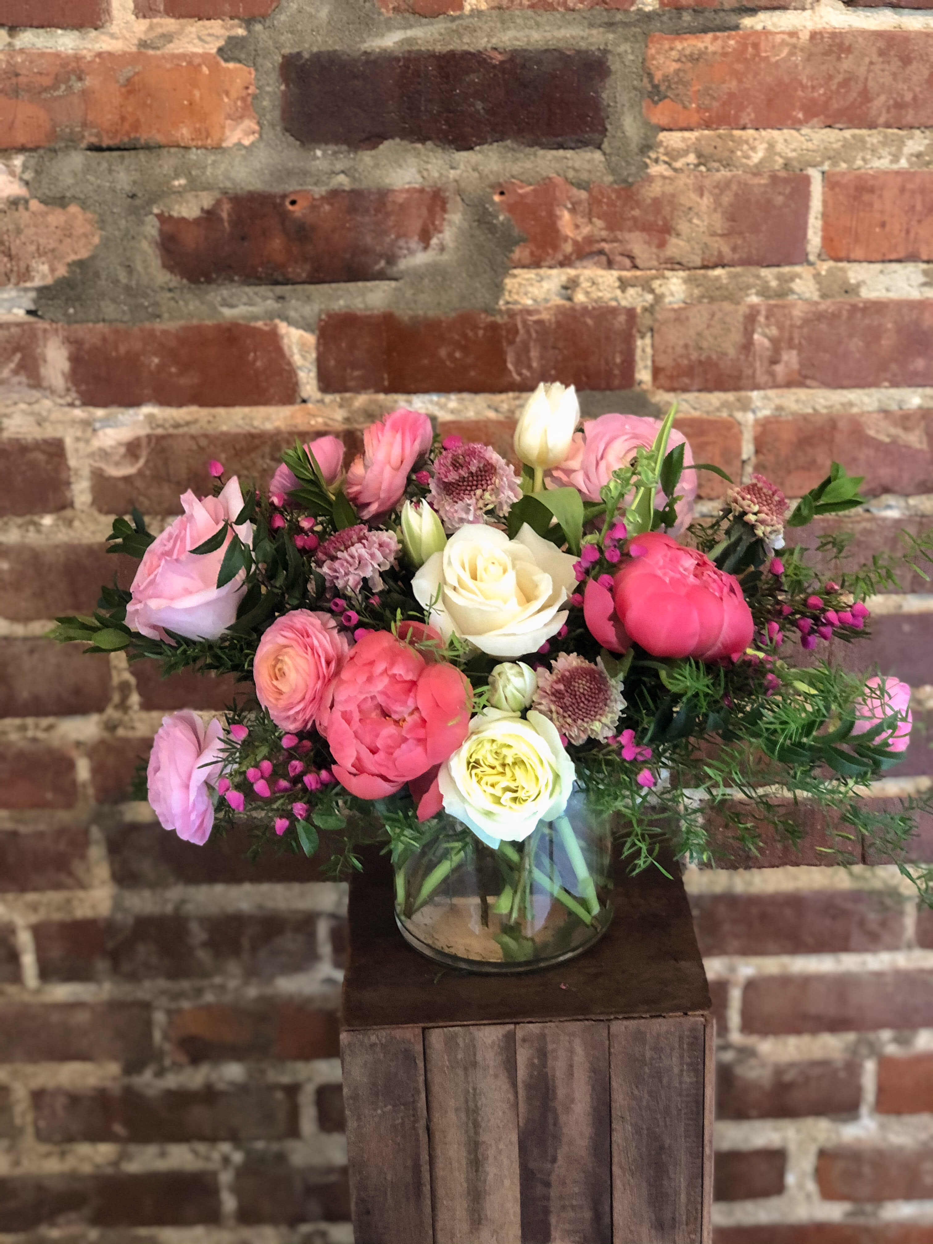 The Abbie - A beautiful pink and white arrangement with fresh, flowing greenery. 