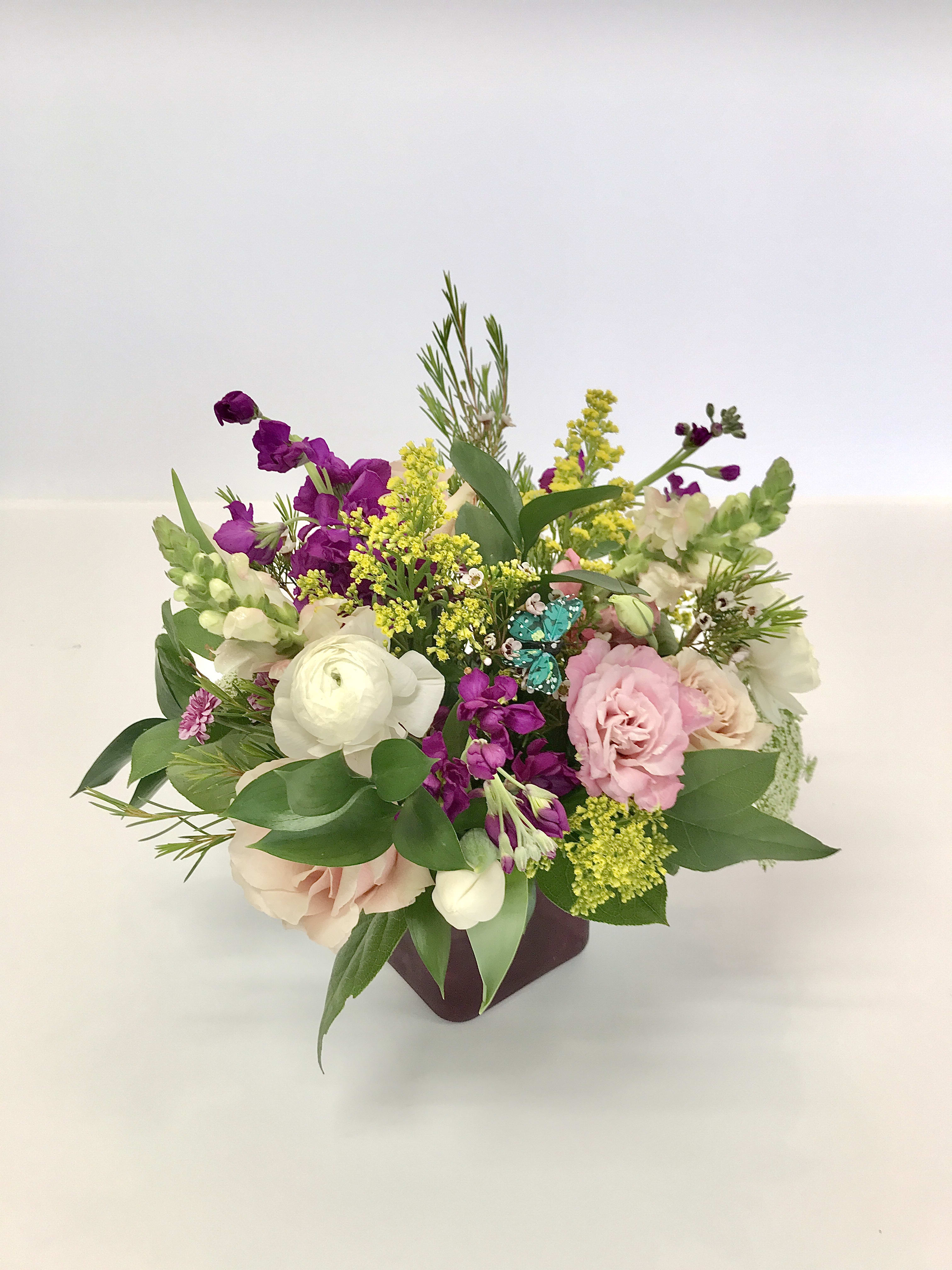 The Leu Gardens  - A custom designed arrangement by Fairbanks Florist. A beautiful collection of mixed seasonal flowers that are fresh in our shop the day of delivery. We try our best to design something similar to what is pictured, but our shop does custom design - so each arrangement is a little different, but has the same spirit, beauty and freshness.  The vase will be clear instead of a color!  Your arrangement will be designed in the style shown but flowers and containers may be different from that pictured. Our designers make every effort to use the best floral selection of the day.