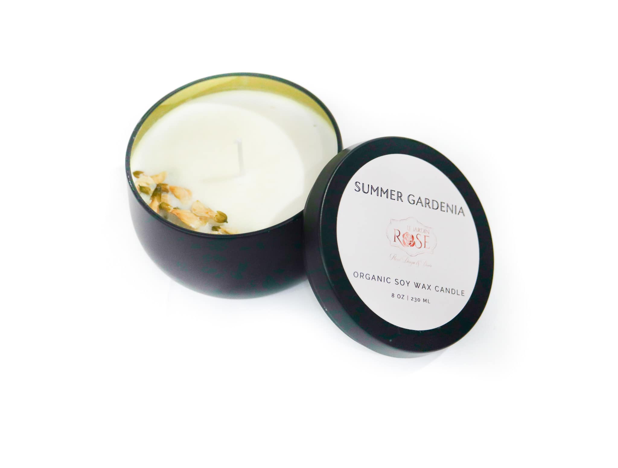 Black tin candle with a lid labeled Summer Gardenia Rose