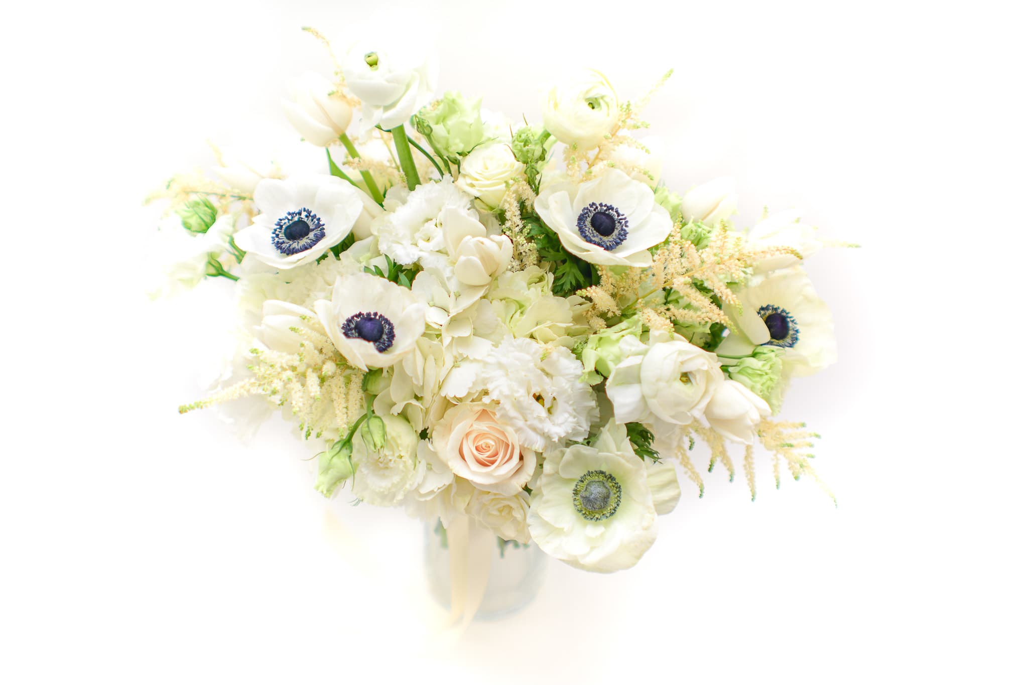 White bouquet with anemones, roses, and pale filler flowers