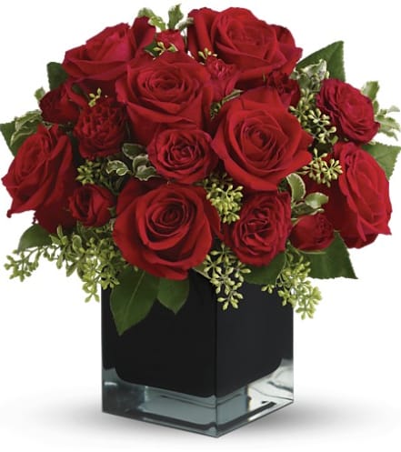 Red roses arranged in a black square vase