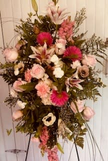 Tall pink and white floral standing spray on an easel