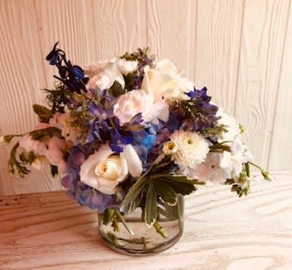 Bouquet of white and blue flowers in a glass vase