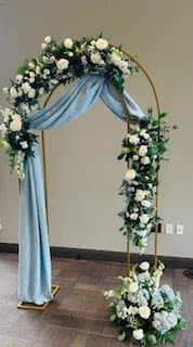 Floral arch with white flowers and blue draping fabric