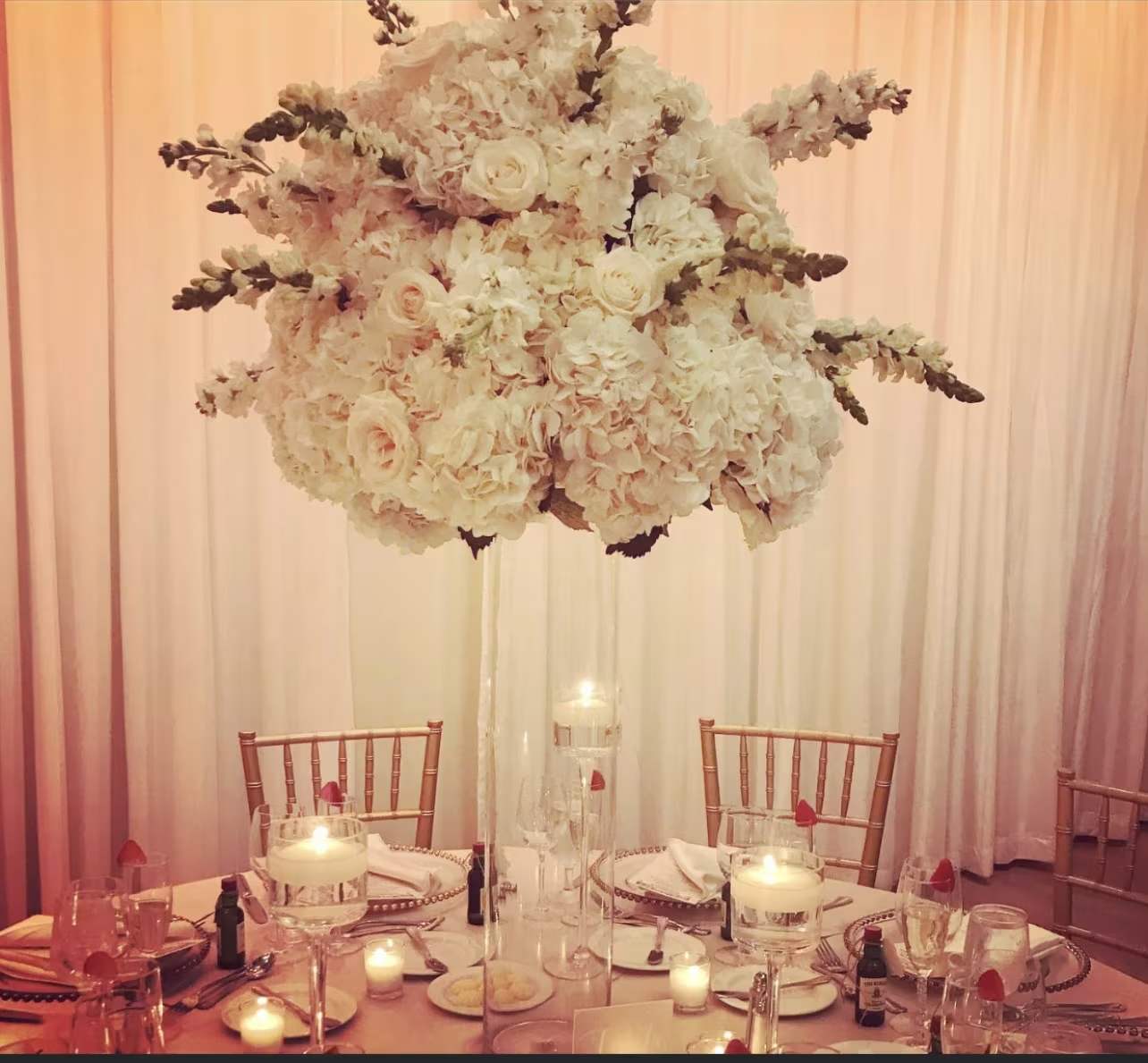 Victorian Hydrangea  - This tall centerpiece is a striking decorative designed.  Victorian style lushly full with hydrangea of your choice of color (vase rented)