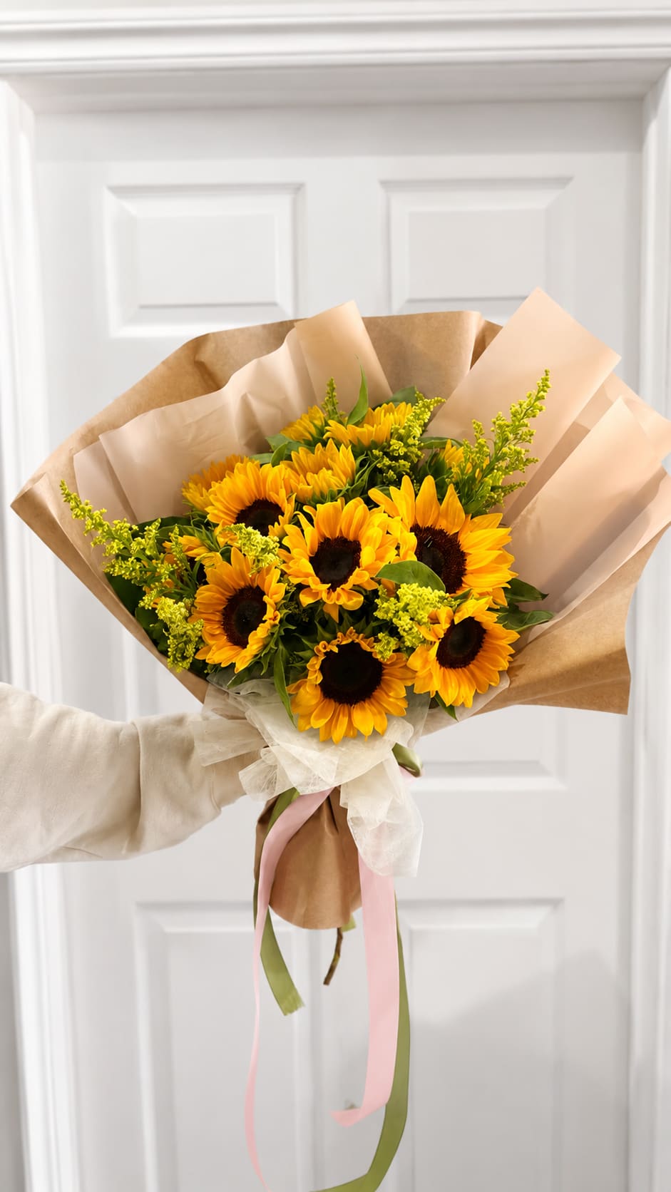 SUNFLOWER FIELDS - A burst of warm, sunny cheer-this sunflower arrangement is built around a dense cluster of bright yellow sunflowers with dark centers, the perfect birthday bouquet or cheerful thank-you gift. The rounded, hand-tied shape presents an immediate, jubilant impression that will make the person you're thinking of feel seen and uplifted, especially for casual gifting or to bring summer brightness indoors.