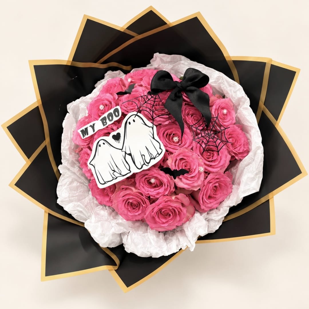 Pink rose bouquet with Halloween ghost decorations and black ribbon