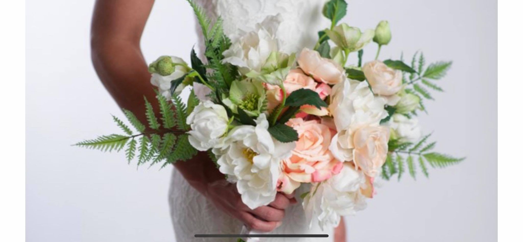Bouquet of white and peach roses with greenery