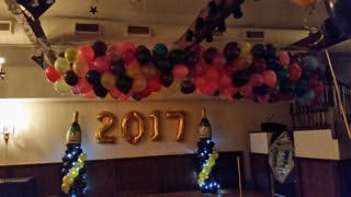 Balloon garland with gold "2017" numbers at an indoor party
