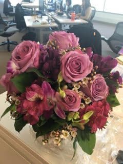 Pink roses and magenta flowers in a hand-tied bouquet