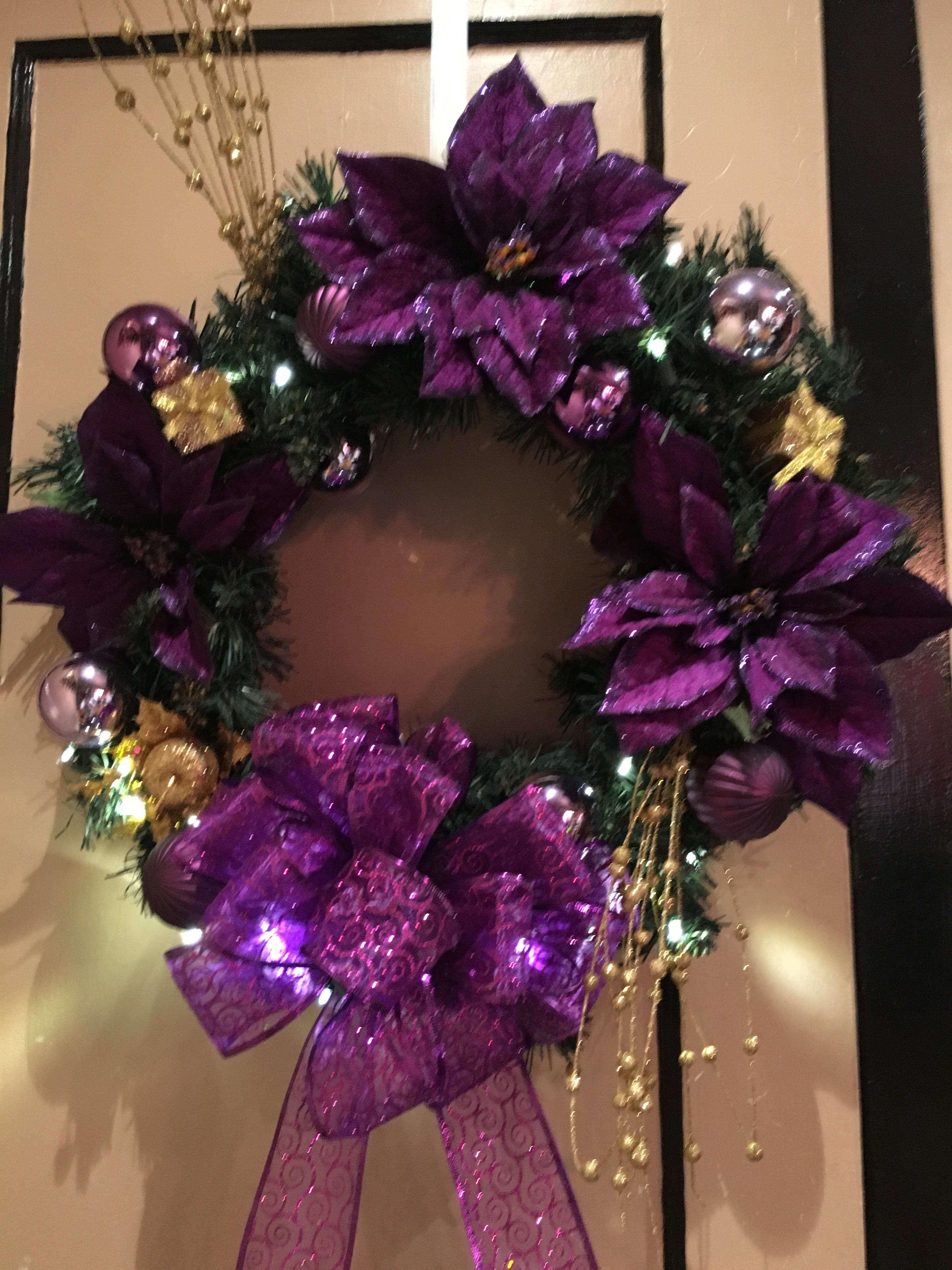 Purple decorated wreath with bows and ornaments