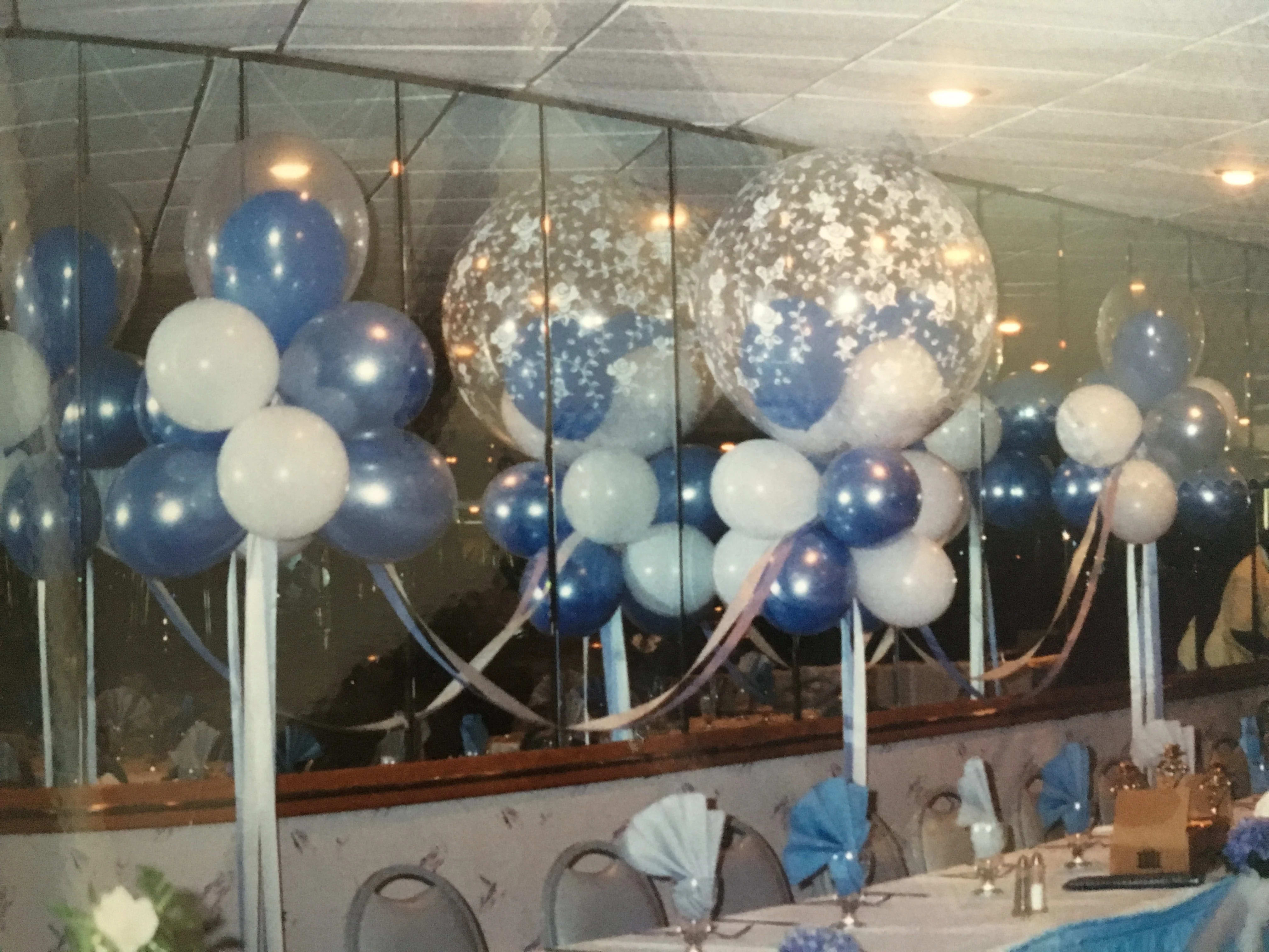 Blue and white balloon decorations at a banquet table setup