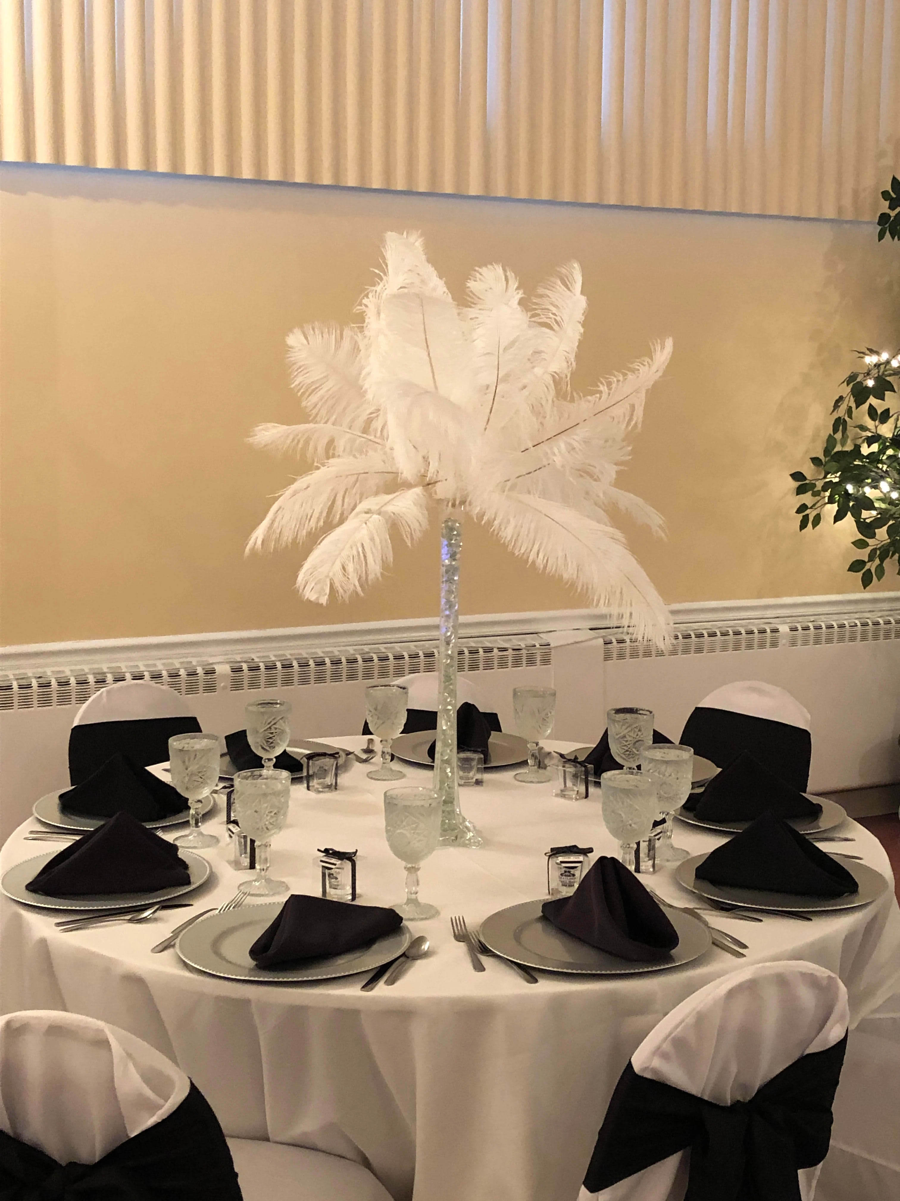 Tall white feather centerpiece on a banquet table