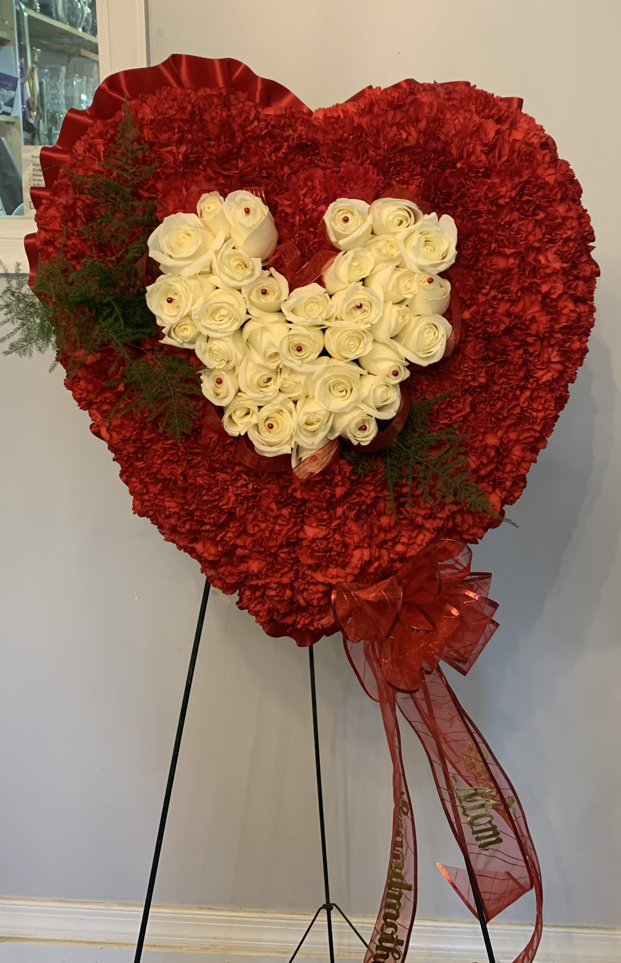 Heart-shaped red floral standing arrangement with white roses